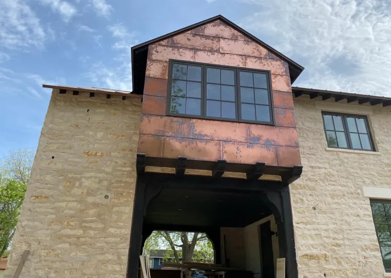 Copper metal panel facade on a stone building for Skylight Installation in Sand Springs