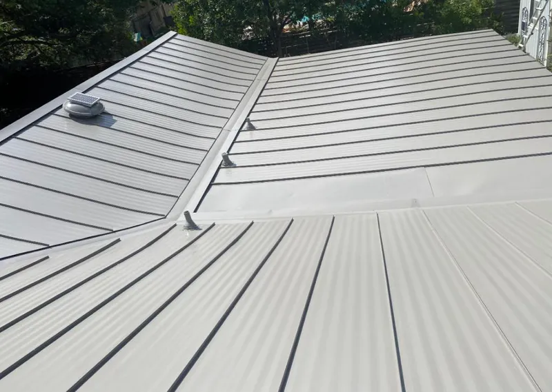 Solar attic fan installed on a metal roof for Roof Ventilation in Sand Springs